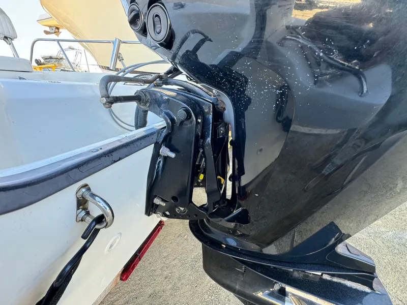 Slide: The Image of 2016 Boston Whaler 170 MONTUCK boat engine close-up, showcasing motor and mounting details. - 11