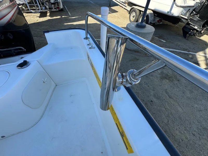 Slide: The Image of 2016 Boston Whaler 170 MONTUCK boat interior with stainless steel railing and rod holder. - 22