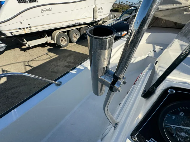 Slide: The Image of 2016 Boston Whaler 170 MONTUCK boat interior with rod holder and dashboard view. - 24