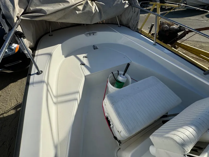 Slide: The Image of 2016 Boston Whaler 170 MONTUCK boat interior with seating and cover. - 28