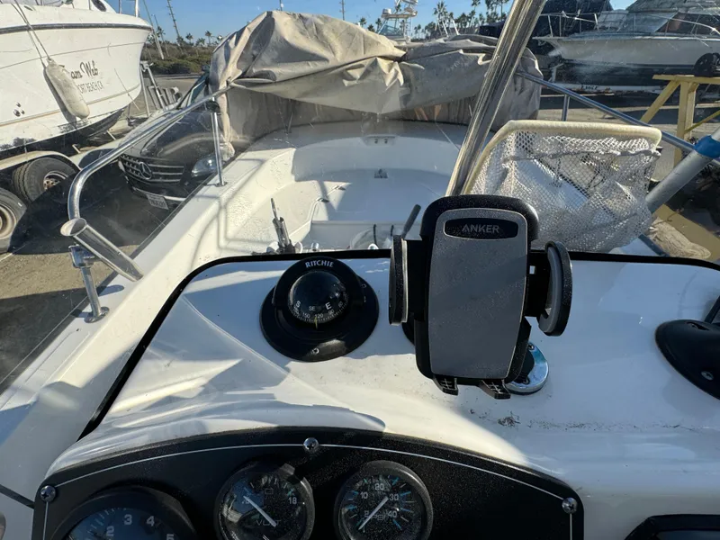 Slide: The Image of 2016 Boston Whaler 170 MONTUCK boat dashboard with compass and phone holder. - 31