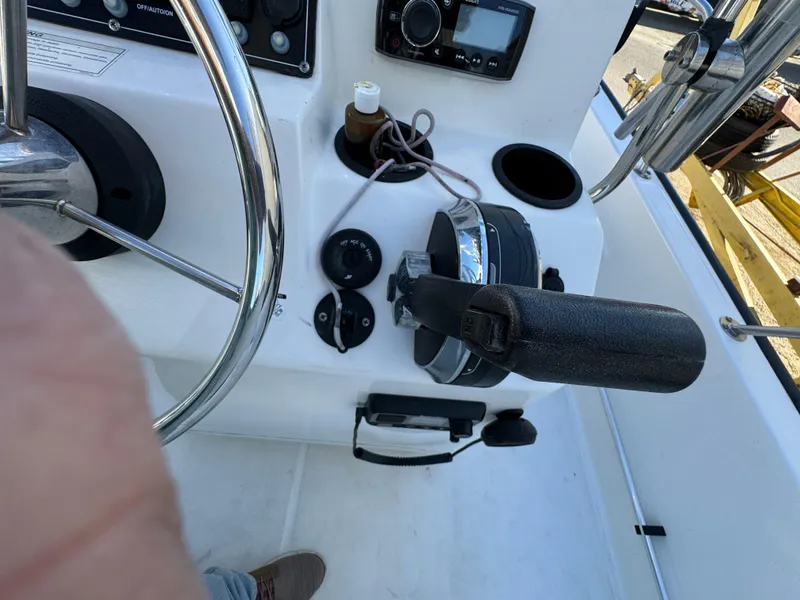 Slide: The Image of 2016 Boston Whaler 170 MONTUCK boat dashboard with steering wheel and controls. - 33
