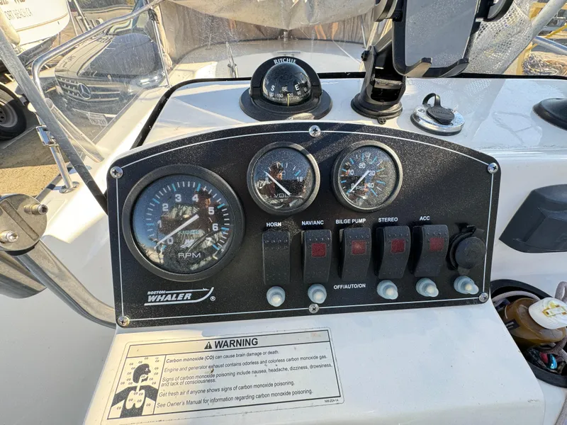 Slide: The Image of Control panel of a 2016 Boston Whaler 170 MONTUCK boat with gauges and switches. - 37