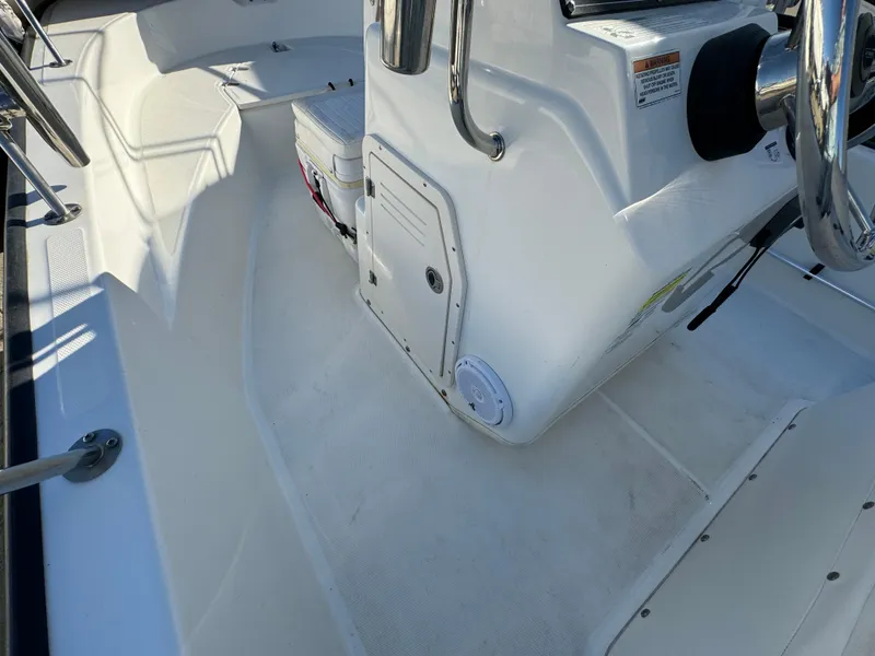 Slide: The Image of 2016 Boston Whaler 170 MONTUCK boat interior with steering console and seating area. - 38