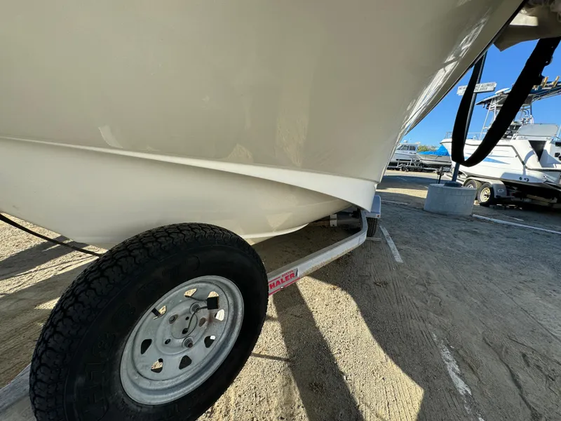 Slide: The Image of 2016 Boston Whaler 170 MONTUCK boat on trailer, close-up view of hull and wheel. - 4