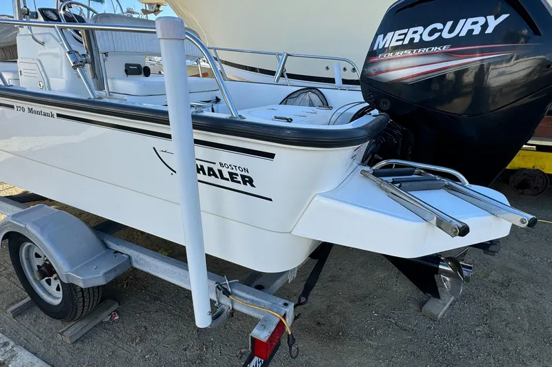 Slide: The Image of 2016 Boston Whaler 170 Montauk boat with Mercury outboard engine on trailer. - 42