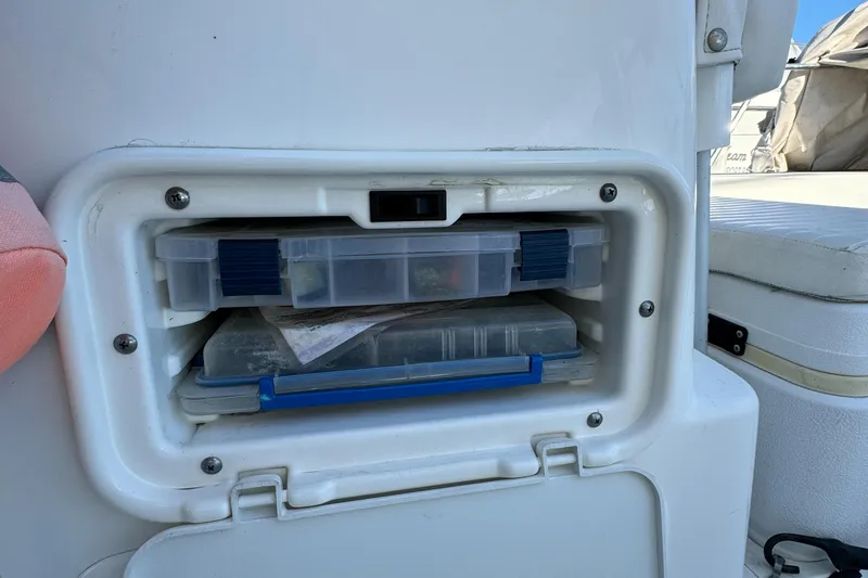 Slide: The Image of Storage compartment on a 2016 Boston Whaler 170 MONTUCK boat with tackle boxes. - 44