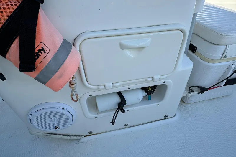 Slide: The Image of 2016 Boston Whaler 170 MONTUCK boat interior with storage compartments and safety equipment. - 45