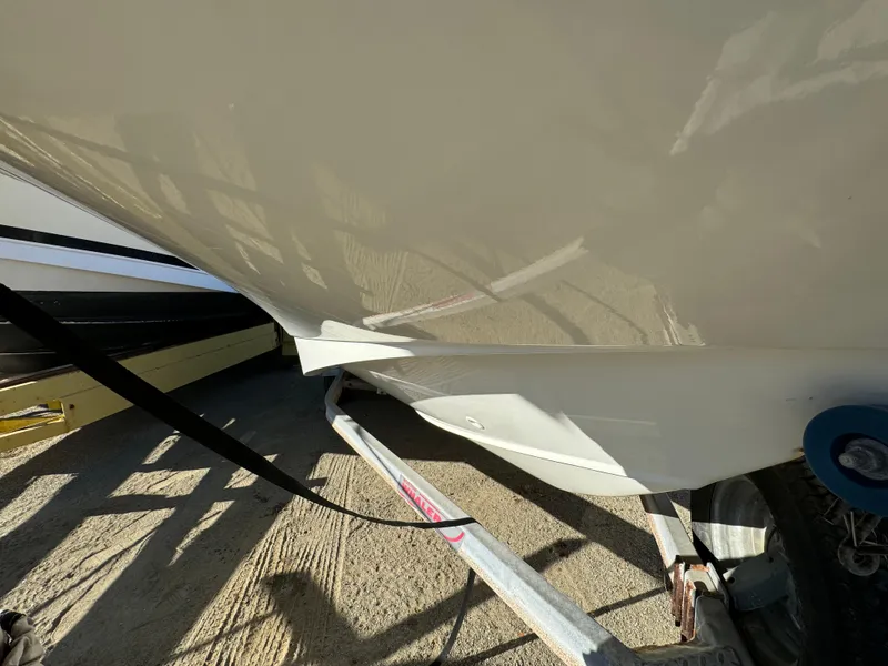 Slide: The Image of 2016 Boston Whaler 170 MONTUCK boat on trailer, close-up view of hull and wheel. - 5