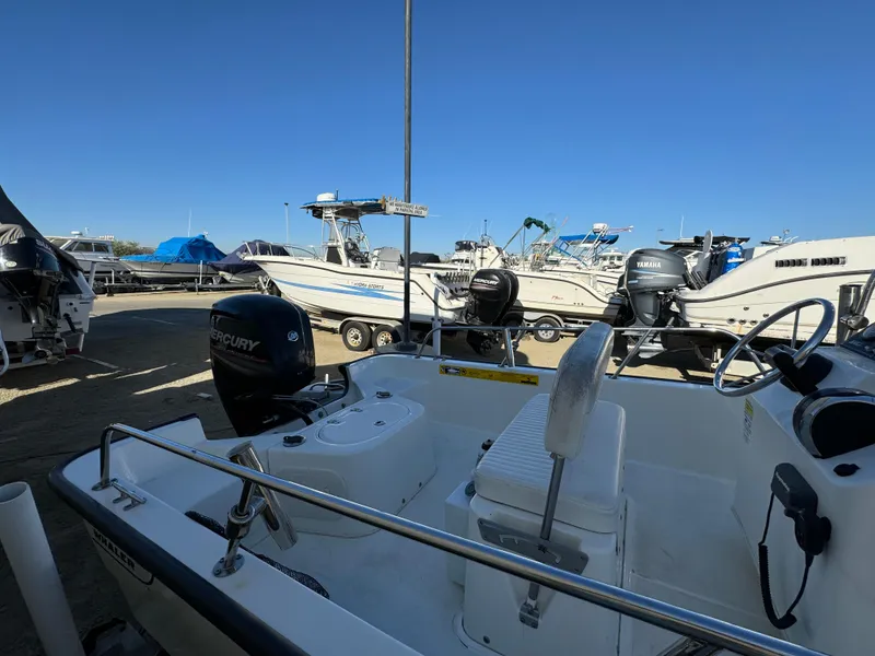 Slide: The Image of 2016 Boston Whaler 170 MONTUCK boat in marina, surrounded by other boats. - 8