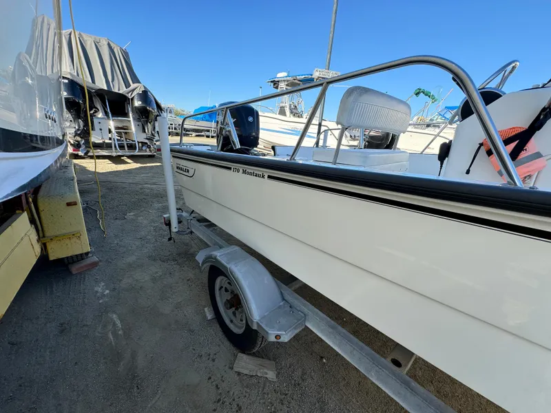 Slide: The Image of 2016 Boston Whaler 170 MONTUCK boat on trailer, parked outdoors. - 9
