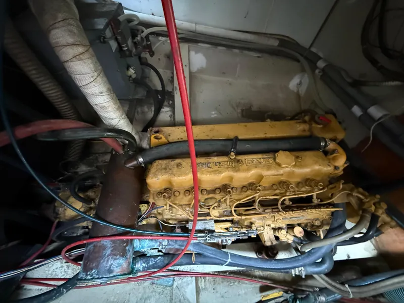 Slide: The Image of Engine room of a 1973 Islander 40 sailboat, featuring a vintage marine engine. - 18