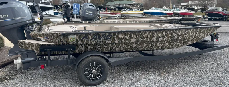 Slide: The Image of 2025 Avid 18 Commander boat with camouflage design on a trailer. - 1