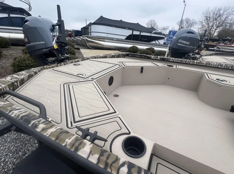 Slide: The Image of 2025 Avid 18 Commander boat with Yamaha outboard motor, camo design, and spacious deck. - 16
