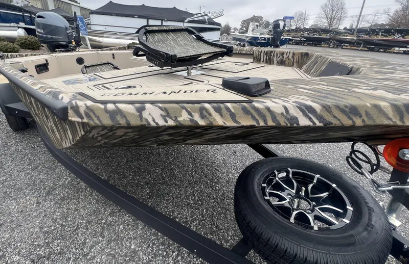 Slide: The Image of 2025 Avid 18 Commander boat with camouflage design on a trailer. - 17