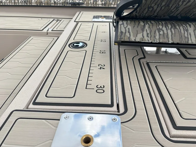 Slide: The Image of 2025 Avid 18 Commander boat deck with ruler and camo seat. - 7