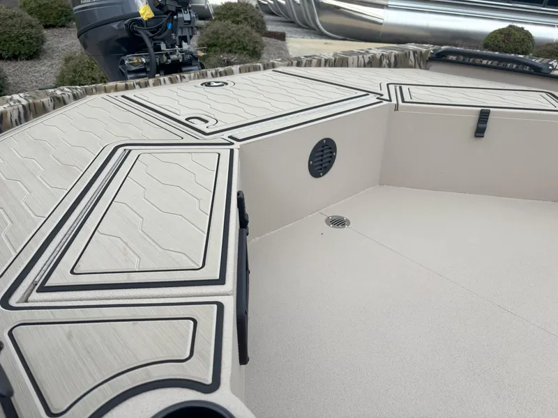 Slide: The Image of 2025 Avid 18 Commander boat deck with storage compartments and motor. - 9