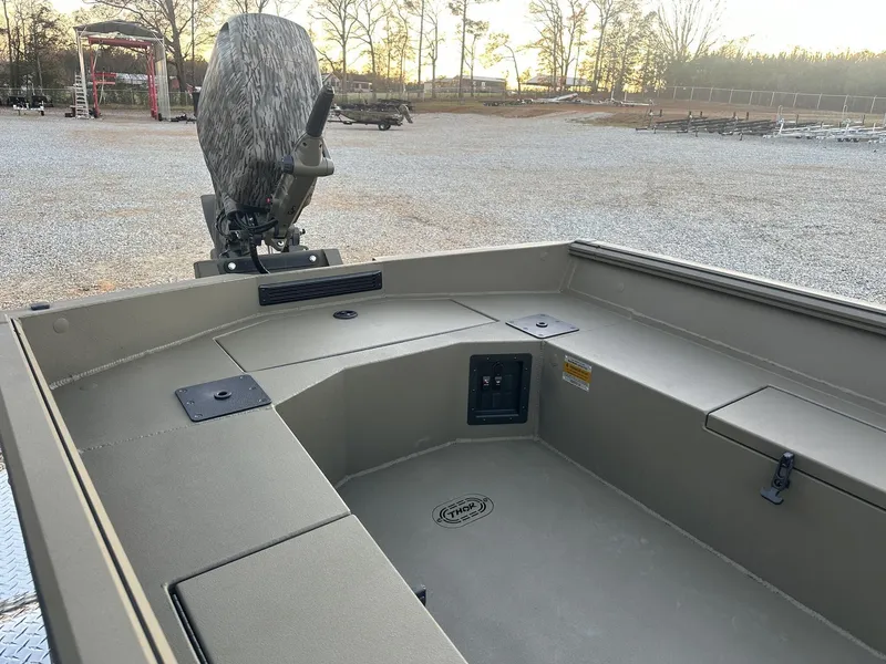 Slide: The Image of 2025 Thor Lake Hammer 1754 boat interior with Tohatsu 60 engine, parked outdoors. - 5