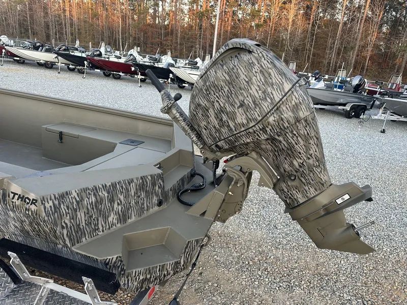 Slide: The Image of 2025 Thor Lake Hammer 1754 with Tohatsu 60 outboard motor in a boat dealership. - 8