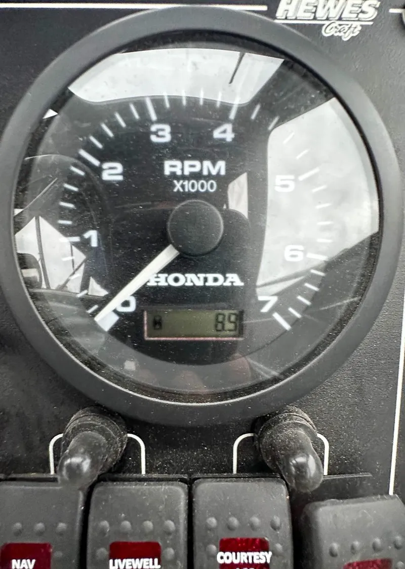 Slide: The Image of Close-up of 2017 Hewescraft 160 Sportsman tachometer showing RPM and switches. - 10