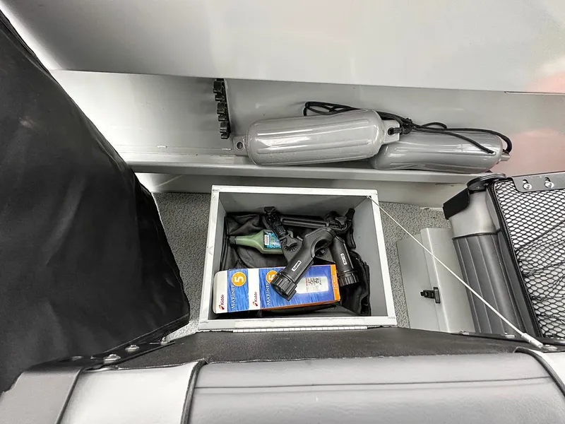Slide: The Image of Storage compartment in 2017 Hewescraft 160 Sportsman boat with gear and accessories. - 14