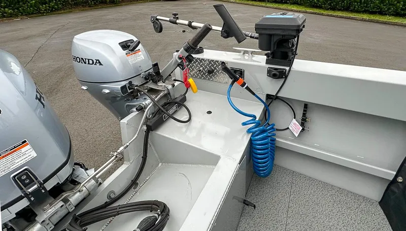 Slide: The Image of 2017 Hewescraft 160 Sportsman boat with Honda outboard motor and steering controls. - 17