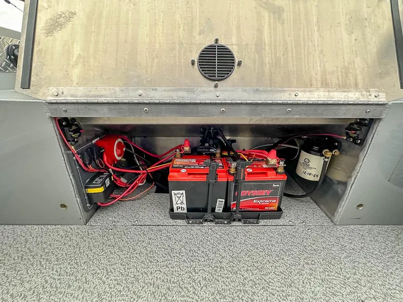 Slide: The Image of 2017 Hewescraft 160 Sportsman battery compartment with Odyssey Extreme batteries and wiring. - 19