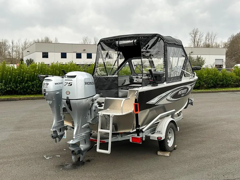 Slide: The Image of 2017 Hewescraft 160 Sportsman boat with dual Honda outboard motors on a trailer. - 2