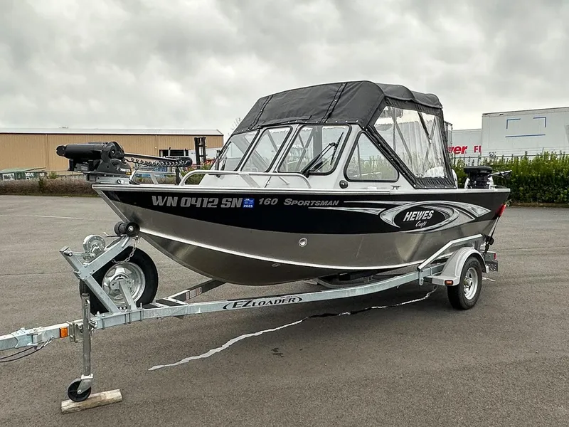 Slide: The Image of 2017 Hewescraft 160 Sportsman boat on trailer, parked outdoors. - 4