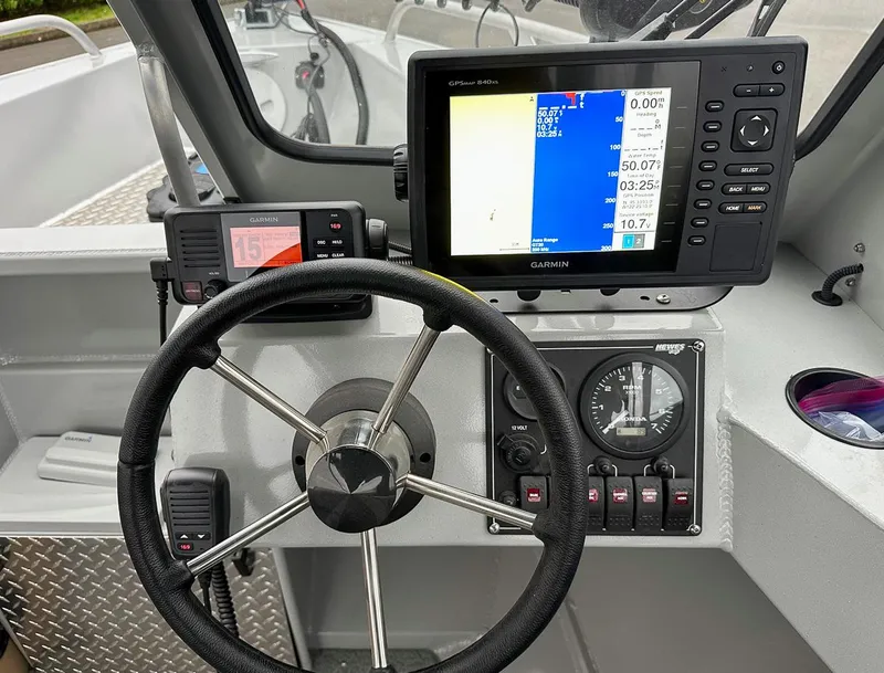 Slide: The Image of 2017 Hewescraft 160 Sportsman boat dashboard with Garmin GPS and steering wheel. - 9