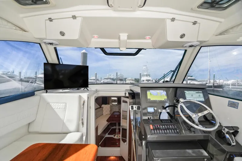 Slide: The Image of Interior of 2023 Pursuit OS 355 Offshore boat with helm, seating, and navigation equipment. - 11