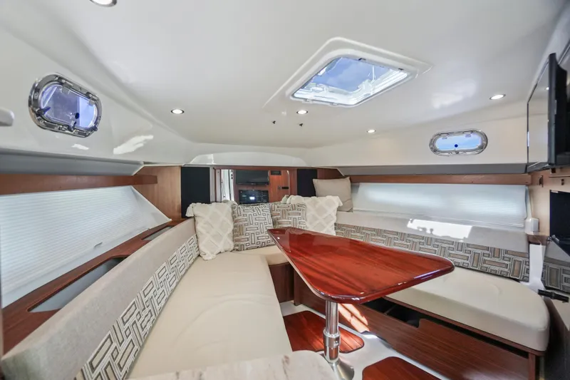 Slide: The Image of Luxurious interior of 2023 Pursuit OS 355 Offshore boat with elegant seating and wooden table. - 12