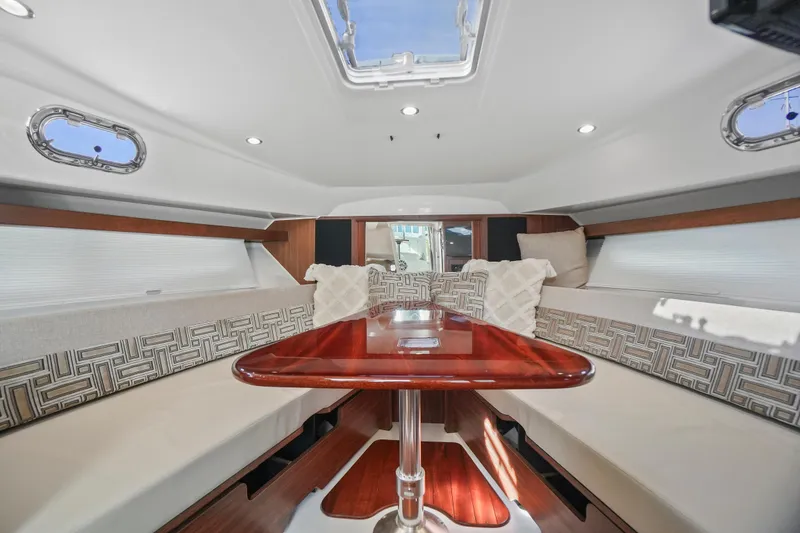 Slide: The Image of Luxurious interior of 2023 Pursuit OS 355 Offshore boat with elegant seating and table. - 15
