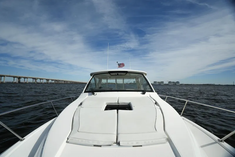 Slide: The Image of 2023 Pursuit OS 355 Offshore boat on open water under blue sky. - 18