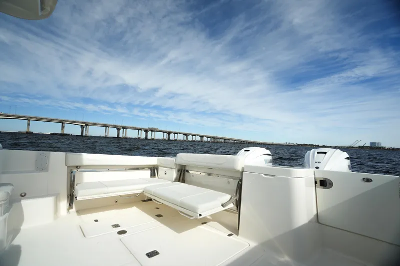 Slide: The Image of 2023 Pursuit OS 355 Offshore boat interior with ocean view and bridge in background. - 20