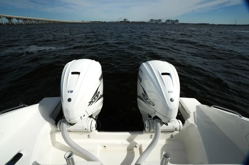 Slide: The Image of 2023 Pursuit OS 355 Offshore boat with twin outboard engines on open water. - 23