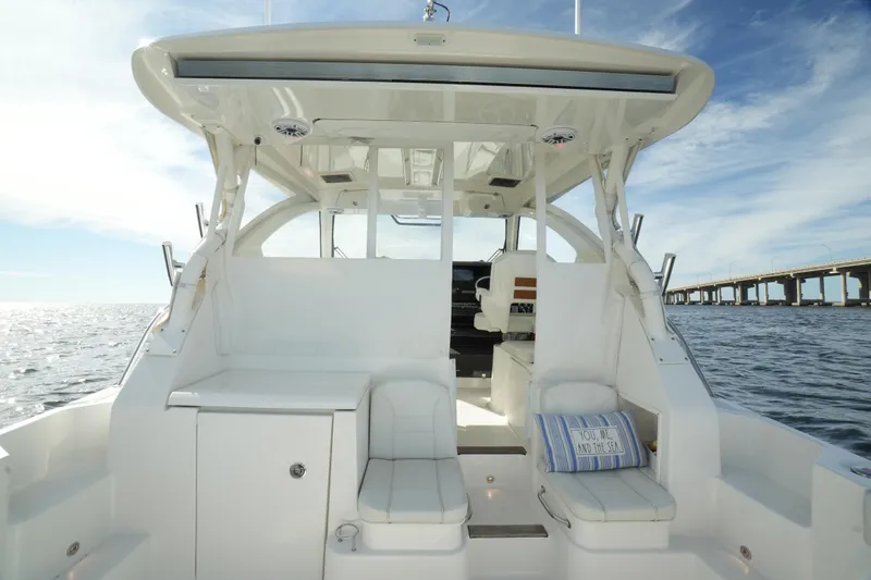 Slide: The Image of 2023 Pursuit OS 355 Offshore boat interior with ocean view and bridge in background. - 25