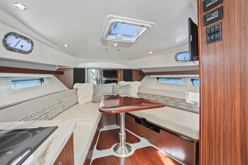 Slide: The Image of Luxurious interior of 2023 Pursuit OS 355 Offshore boat with elegant seating and wood finishes. - 27