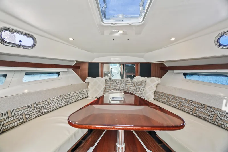 Slide: The Image of Luxurious interior of 2023 Pursuit OS 355 Offshore boat with elegant seating and table. - 28