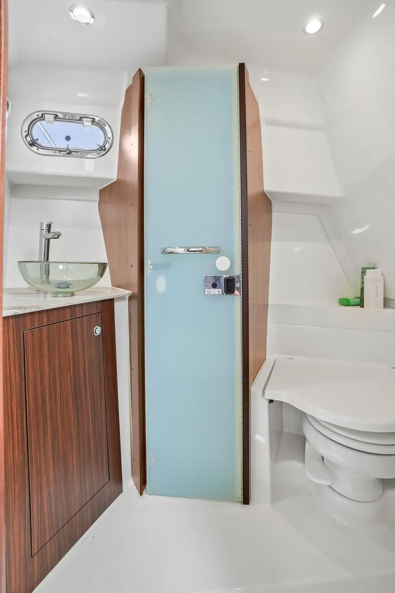 Slide: The Image of 2023 Pursuit OS 355 Offshore boat bathroom with modern fixtures and sleek design. - 31
