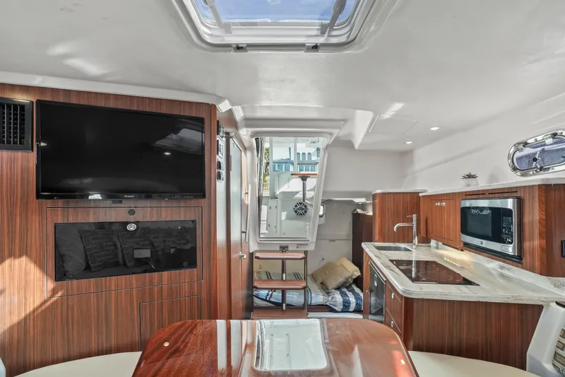 Slide: The Image of Luxurious interior of 2023 Pursuit OS 355 Offshore boat with modern amenities. - 32