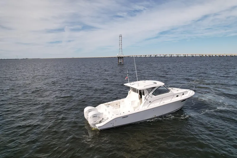 Slide: The Image of 2023 Pursuit OS 355 Offshore boat cruising on open water. - 4