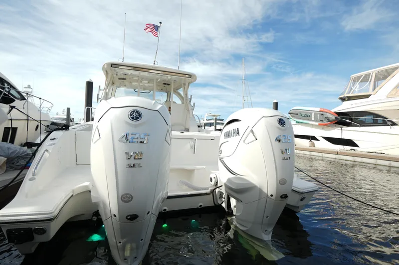 Slide: The Image of 2023 Pursuit OS 355 Offshore boat with twin Yamaha engines docked in marina. - 40