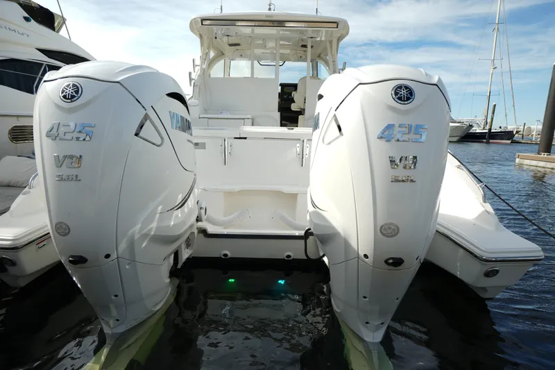 Slide: The Image of 2023 Pursuit OS 355 Offshore boat with twin Yamaha 425 V8 engines docked in marina. - 41