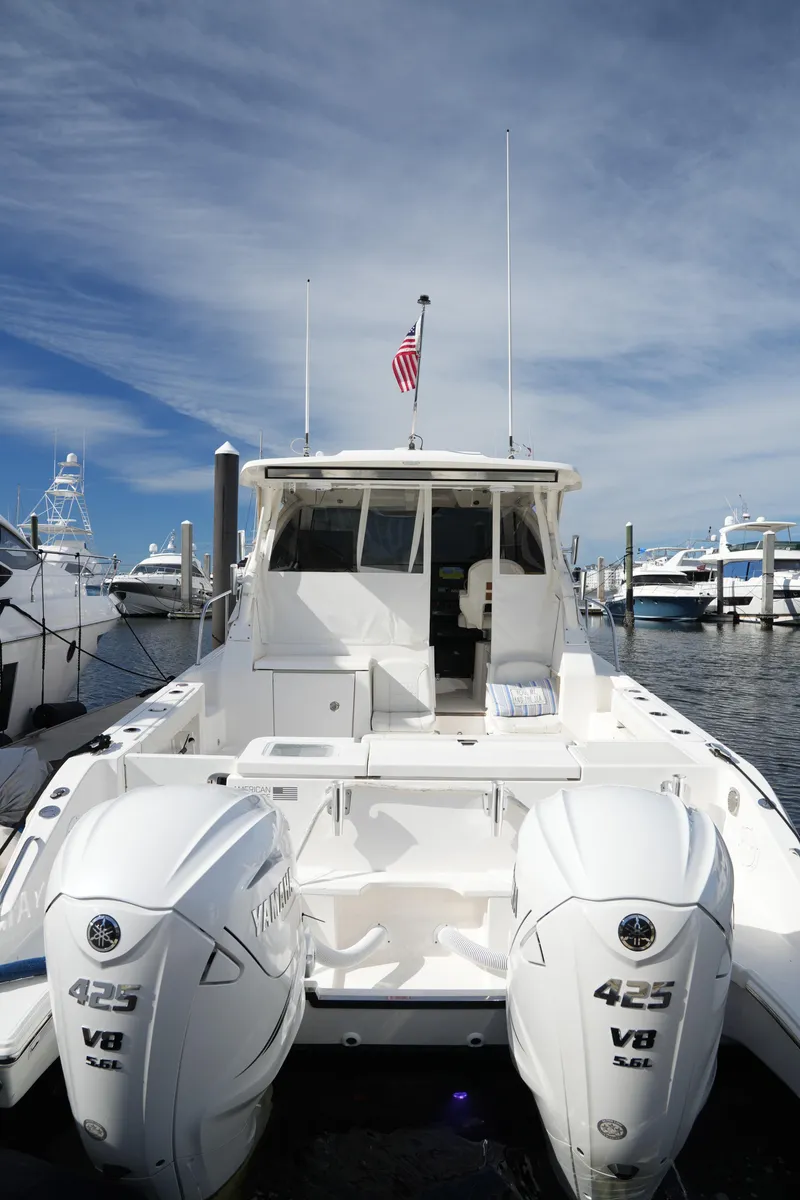 Slide: The Image of 2023 Pursuit OS 355 Offshore boat with twin V8 engines docked at marina. - 43
