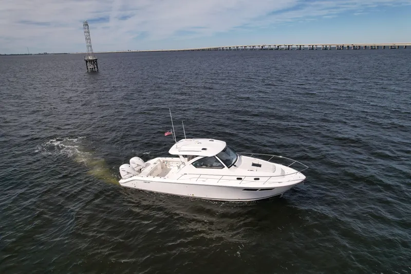 Slide: The Image of 2023 Pursuit OS 355 Offshore boat cruising on open water. - 6