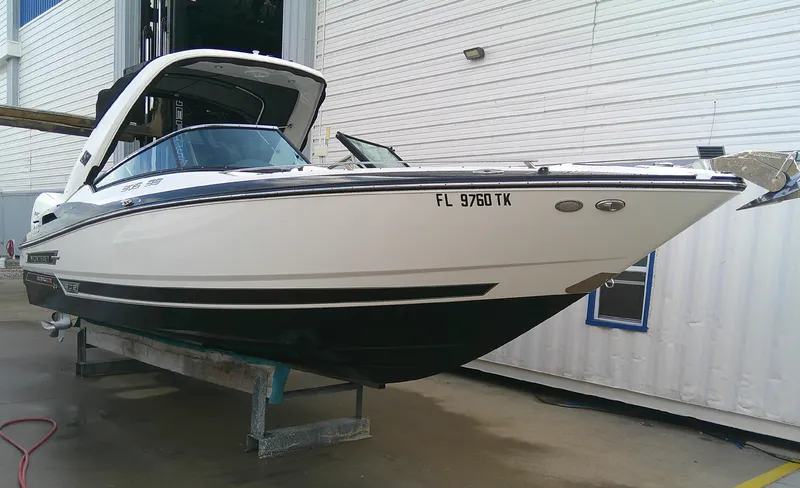The Image of 2020 Monterey 305 Super Sport boat on a lift, white and black exterior. - 0