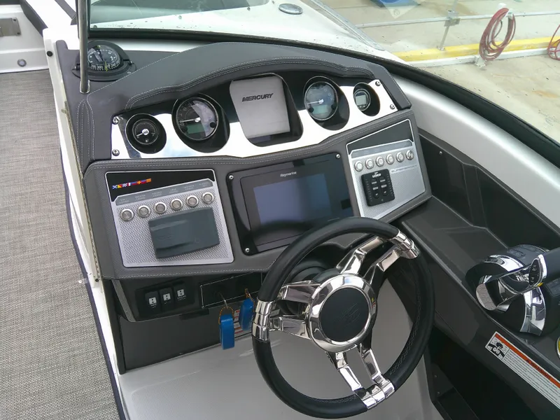 Slide: The Image of Dashboard of 2020 Monterey 305 Super Sport boat with modern controls and steering wheel. - 10