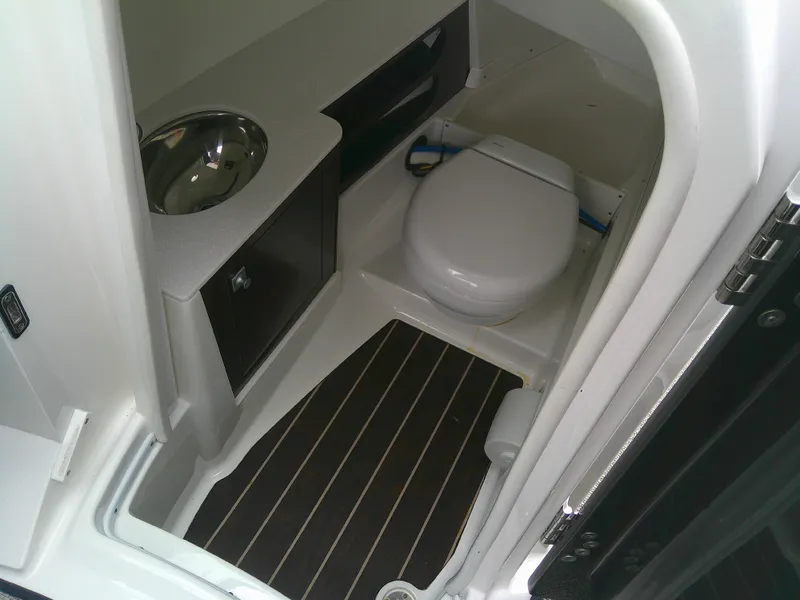 Slide: The Image of 2020 Monterey 305 Super Sport boat bathroom with toilet and sink. - 11