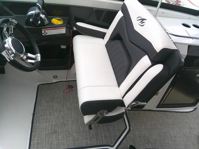 Slide: The Image of Monterey 305 Super Sport 2020 boat interior with steering wheel and cushioned seat. - 14